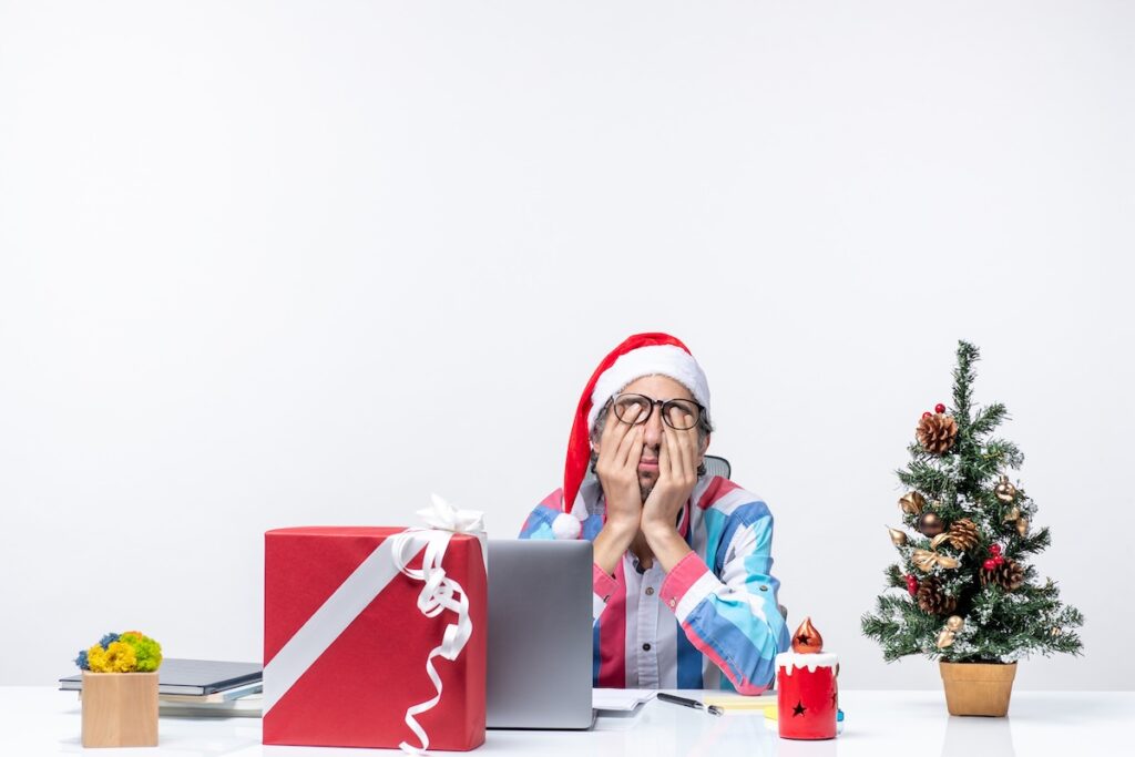 front view male worker sitting his working place feeling tired christmas business job emotion