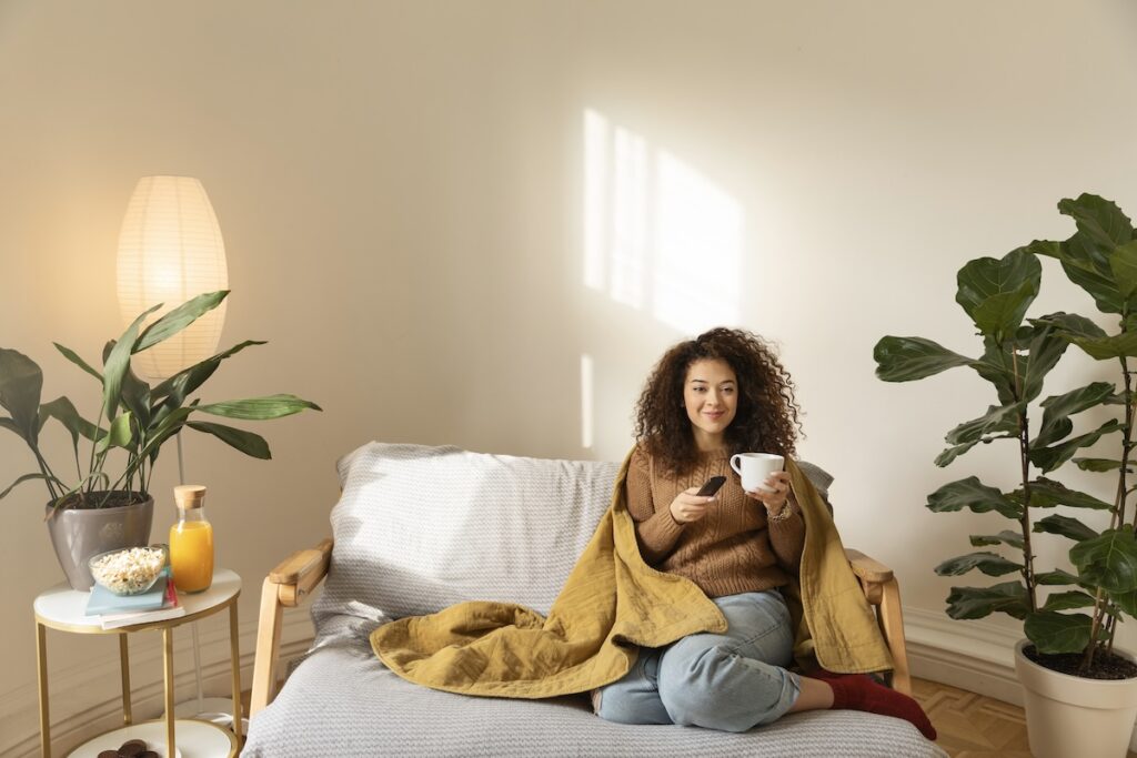 full shot woman sitting couch