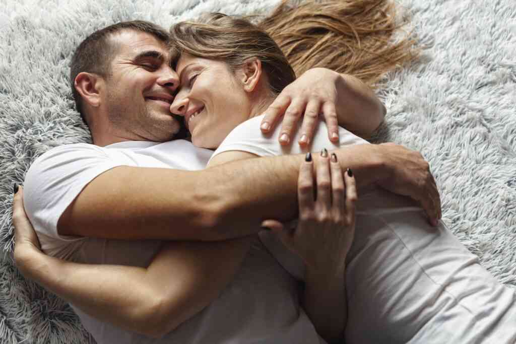 happy couple hugging blanket